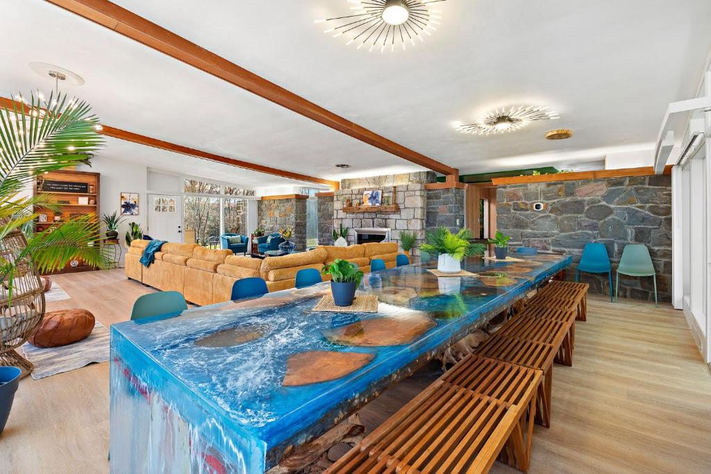 a dining room with a large blue table with benches at 18 bd w Indoor Pool Hottub & Sauna - Mystery Room in East Stroudsburg