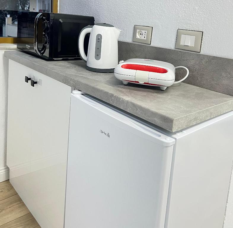 a kitchen counter with a toaster and a appliance on it at Tirana View Apartments in Tirana