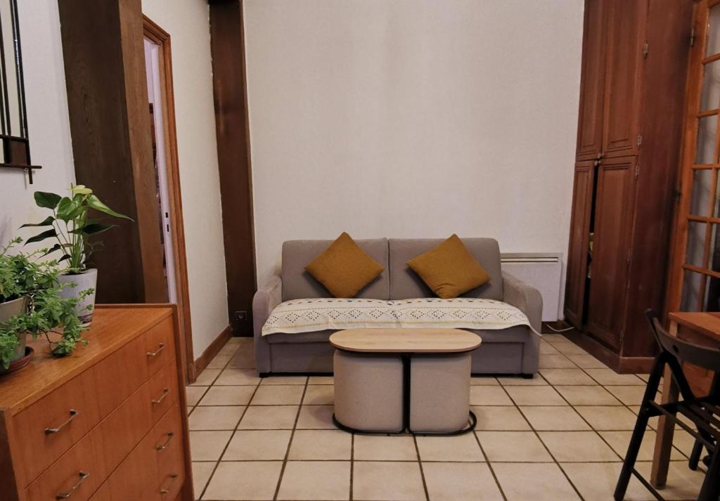 a living room with a couch and a table at L'Cosy Suite - Charming 2BR in Bagnolet in Bagnolet