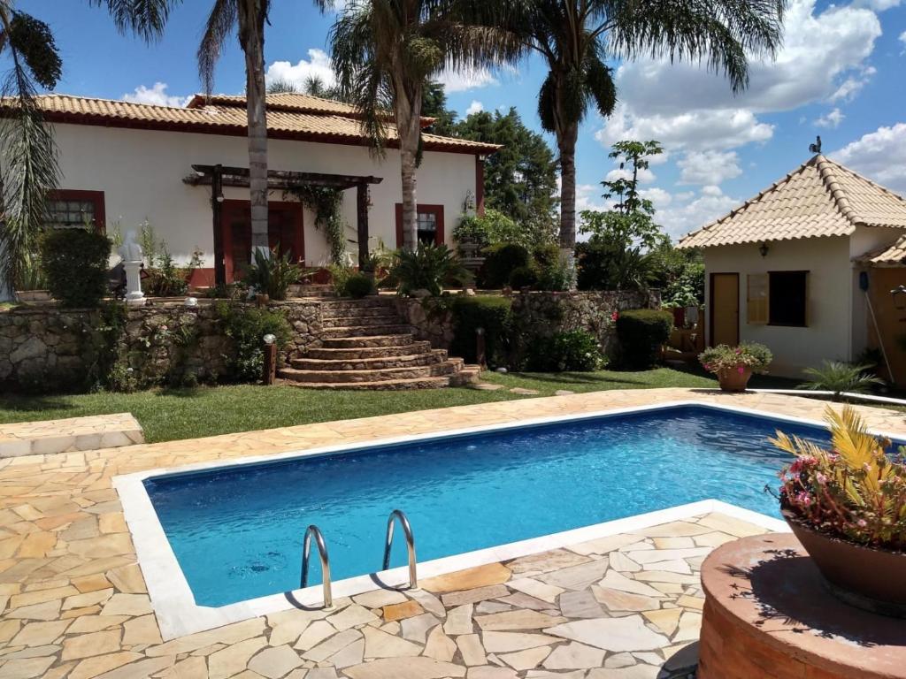 a swimming pool in front of a house at Pousada Santa Bárbara in Tiradentes
