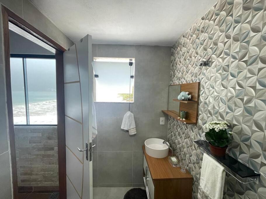a bathroom with a shower with a toilet and a sink at Recanto Luxo Vista Mar in Angra dos Reis