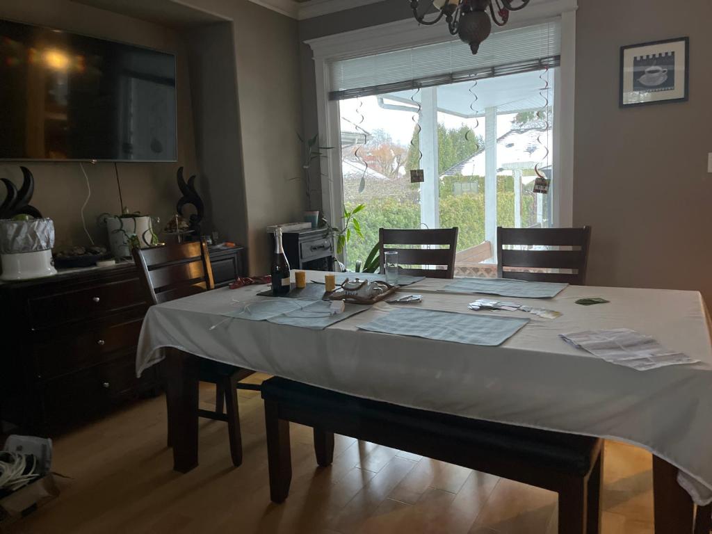 a dining room table with chairs and a window at Hazy home in Richmond