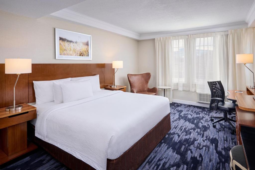 a hotel room with a large bed and a desk at Fairfield Inn & Suites by Marriott Ottawa Kanata in Ottawa