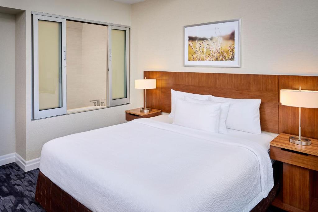 a bedroom with a large white bed and two lamps at Fairfield Inn & Suites by Marriott Ottawa Kanata in Ottawa