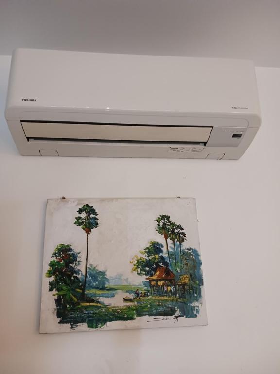 a picture of a painting hanging on a wall at Andy's Place in Siem Reap