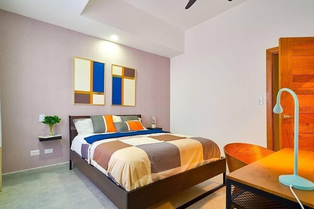 a bedroom with a large bed and a desk at Refa 304 in Santo Domingo