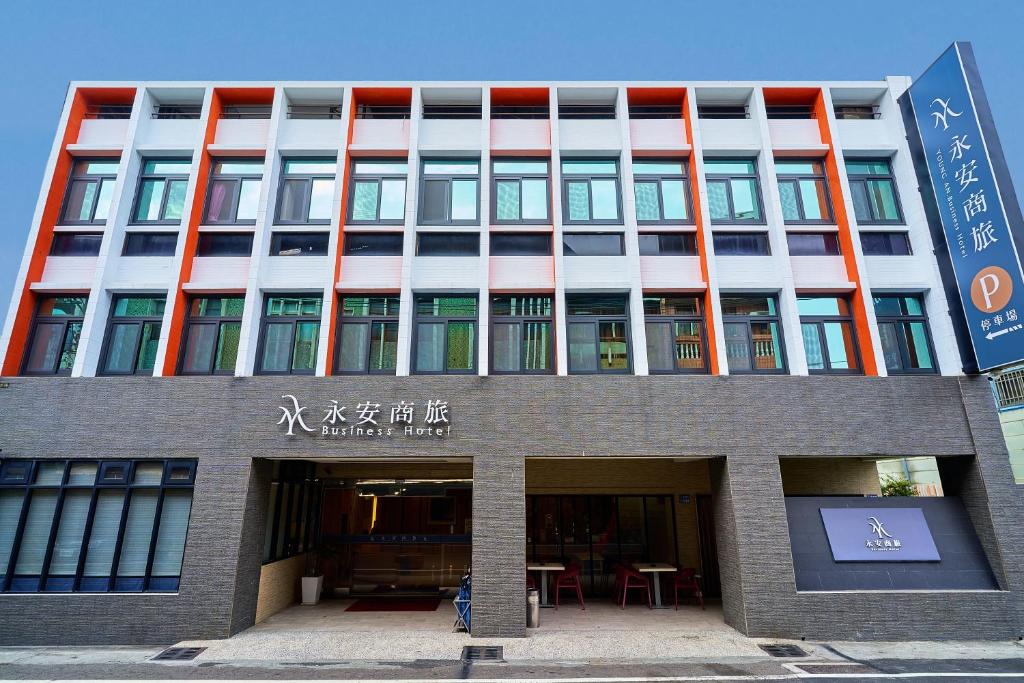 a building with red and white columns on it at Yung An Business Hotel in Dounan