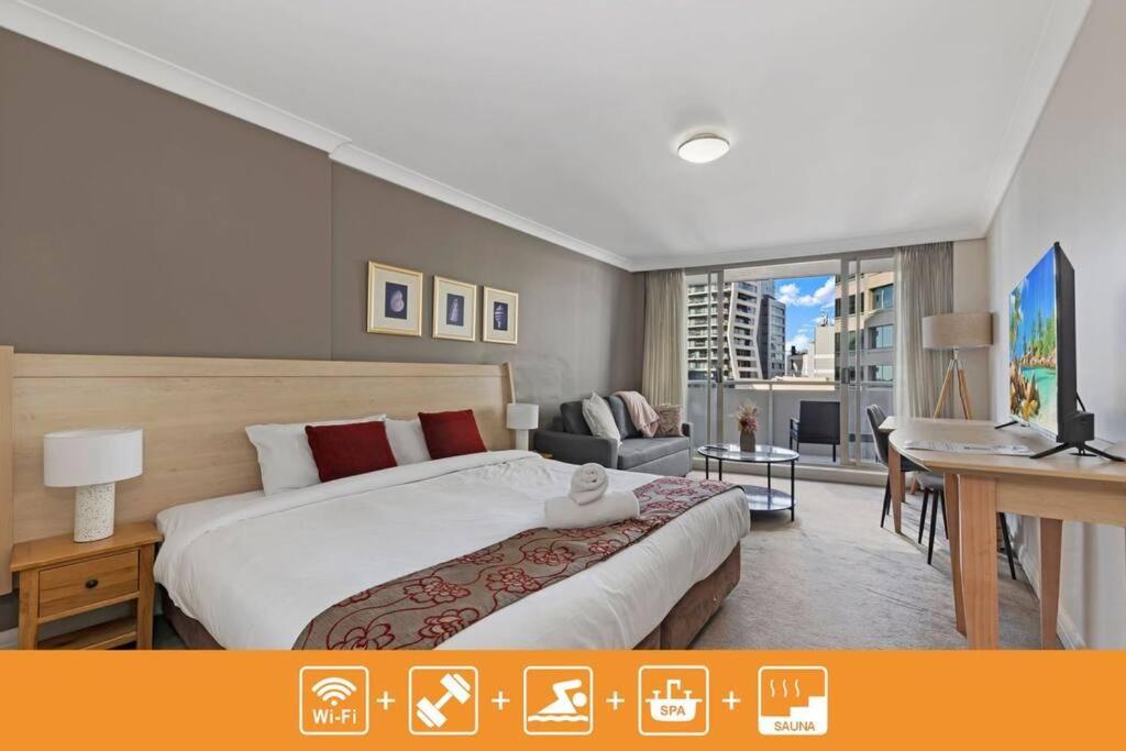 a bedroom with a large bed and a living room at Comfy Studio Next to Chatswood Station in Sydney