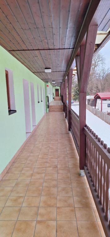 an empty corridor of a building with a wooden ceiling at Sharma's Hotel in Ilmenau