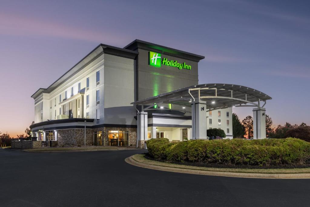 a building with a sign on the front of it at Holiday Inn Anderson, an IHG Hotel in Anderson