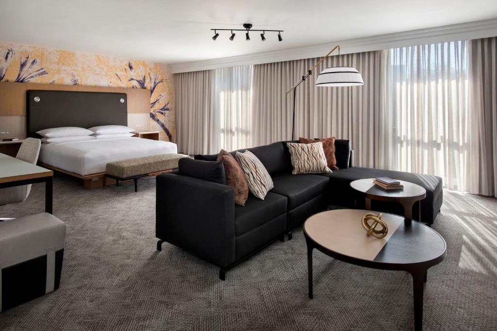 a living room with a couch and a bed at Westchester Marriott in Tarrytown