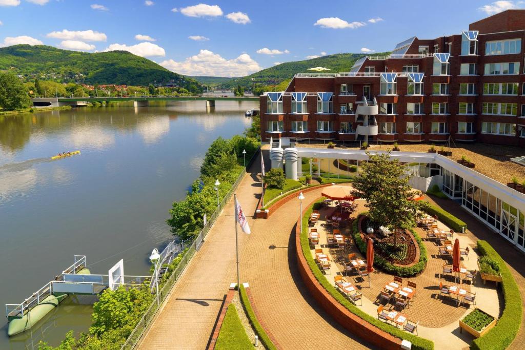 arial view of a hotel with a river and buildings at Heidelberg Marriott Hotel in Heidelberg