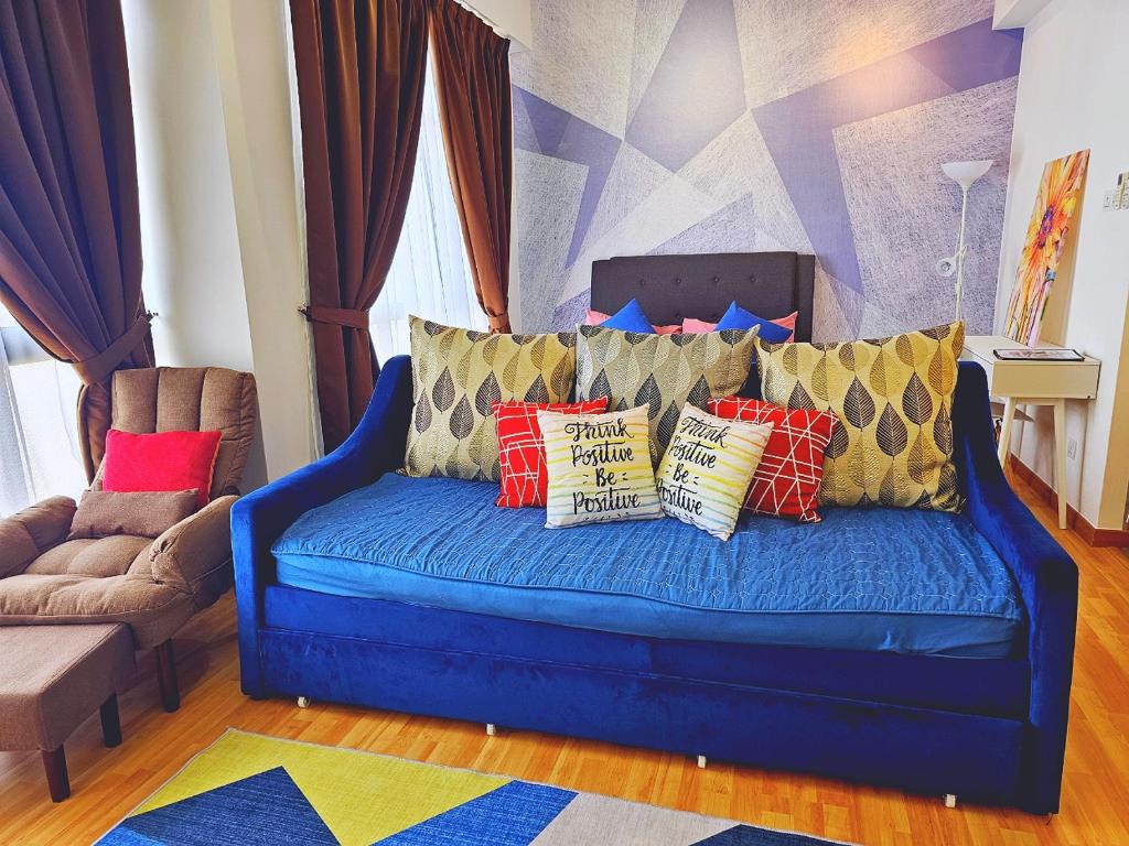 a blue couch with pillows on it in a living room at HomeZz Imperium Residence Kuantan Studio Seaview in Kuantan