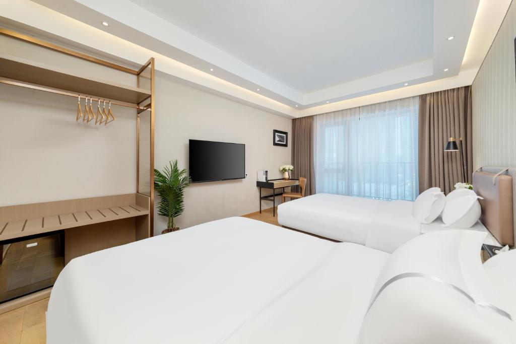 Postel nebo postele na pokoji v ubytování Doria Home International Apartment -Guangzhou Huijin IFC Keyun Road Metro Branch-Canton Fair Free Shuttle