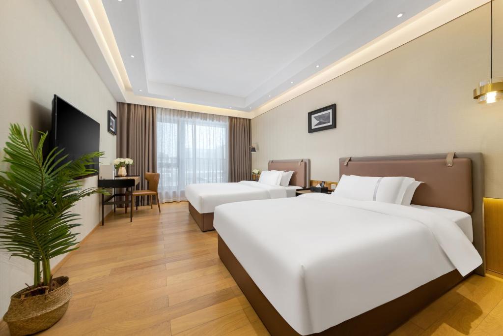TV a/nebo společenská místnost v ubytování Doria Home International Apartment -Guangzhou Huijin IFC Keyun Road Metro Branch-Canton Fair Free Shuttle
