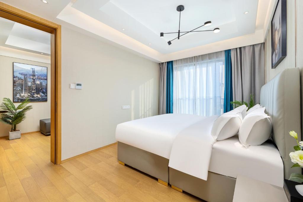 Postel nebo postele na pokoji v ubytování Doria Home International Apartment -Guangzhou Huijin IFC Keyun Road Metro Branch-Canton Fair Free Shuttle