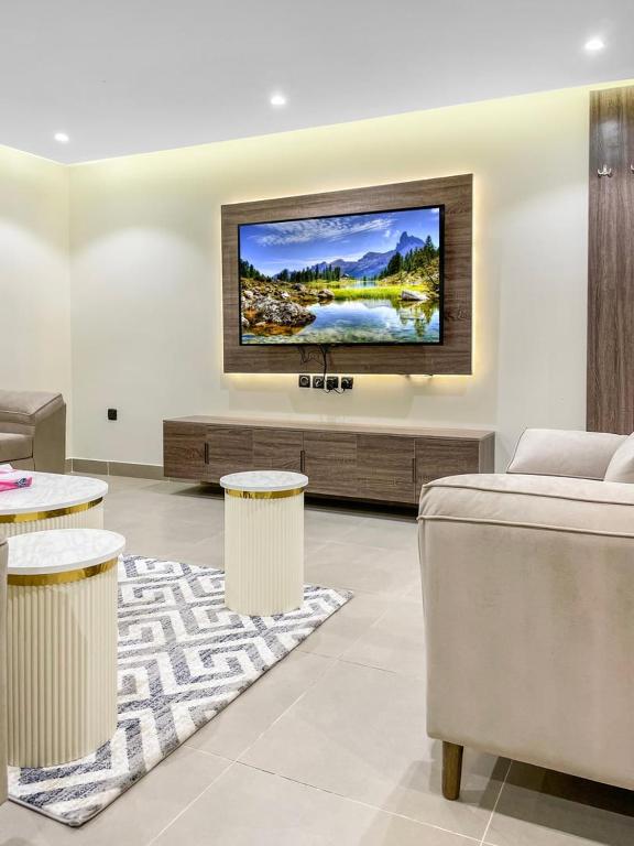a living room with a tv on a wall at GR - A quiet bedroom apartment 10 in Riyadh