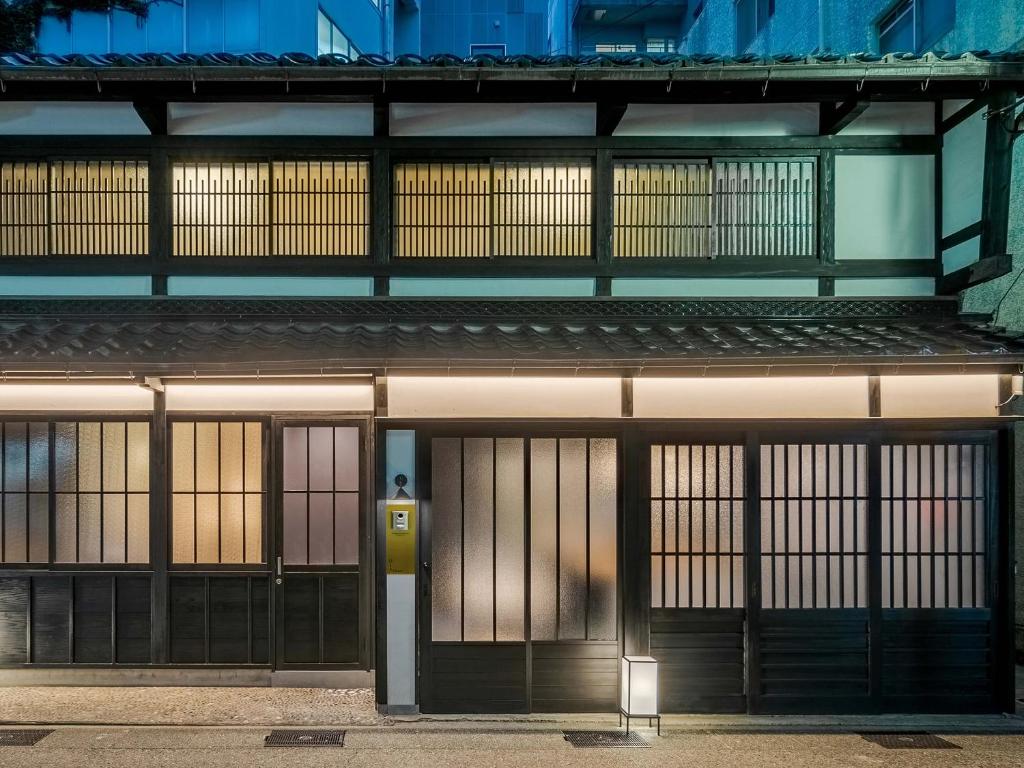 an entrance to a building with two garage doors at Hotori Machiya House in Kanazawa