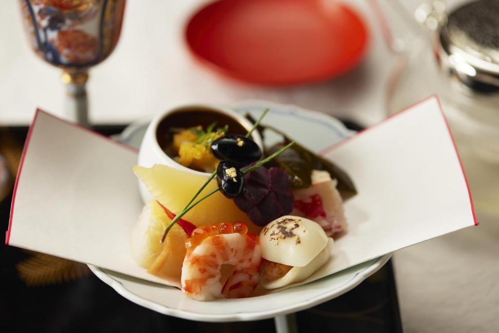 a plate of food with sushi on a table at Waqoo Naritasanmonzen in Narita
