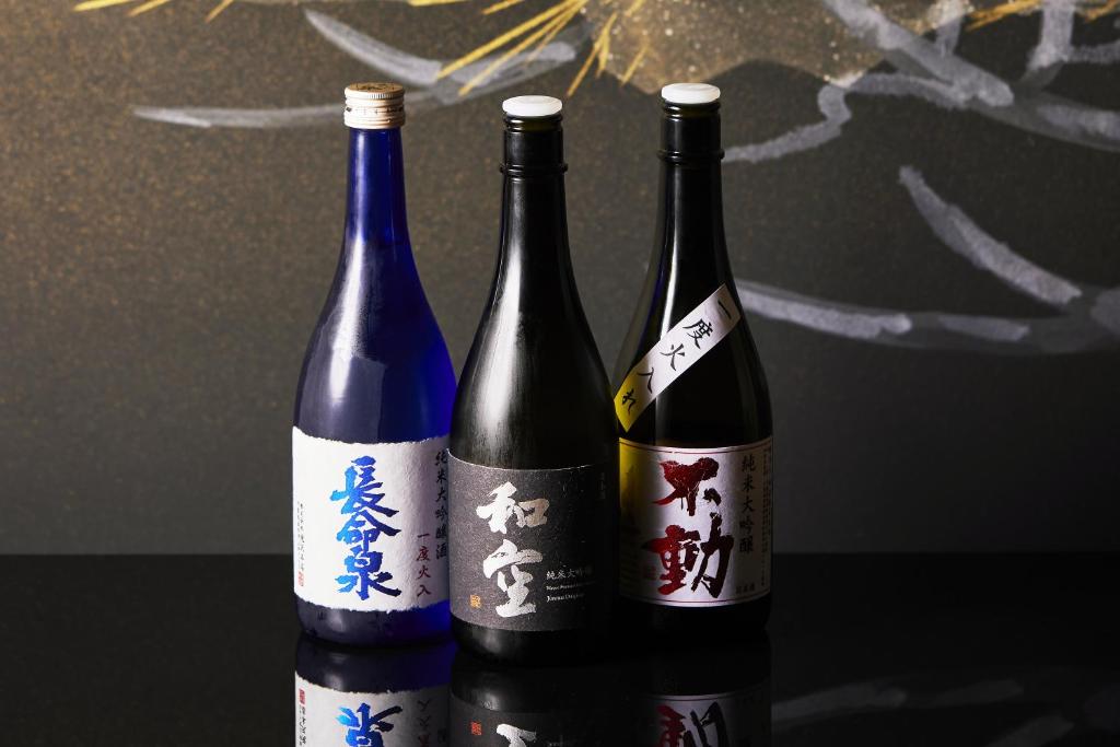 three bottles of wine sitting next to each other at Waqoo Naritasanmonzen in Narita