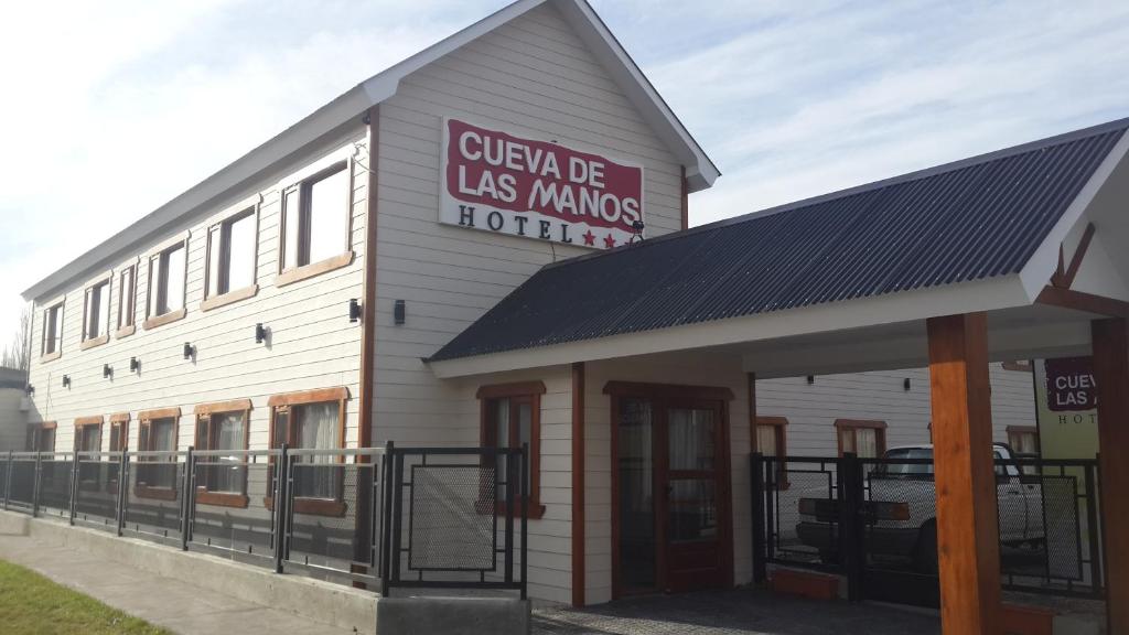 un bâtiment avec un panneau sur son côté dans l'établissement Hotel Cueva de las Manos, à Perito Moreno