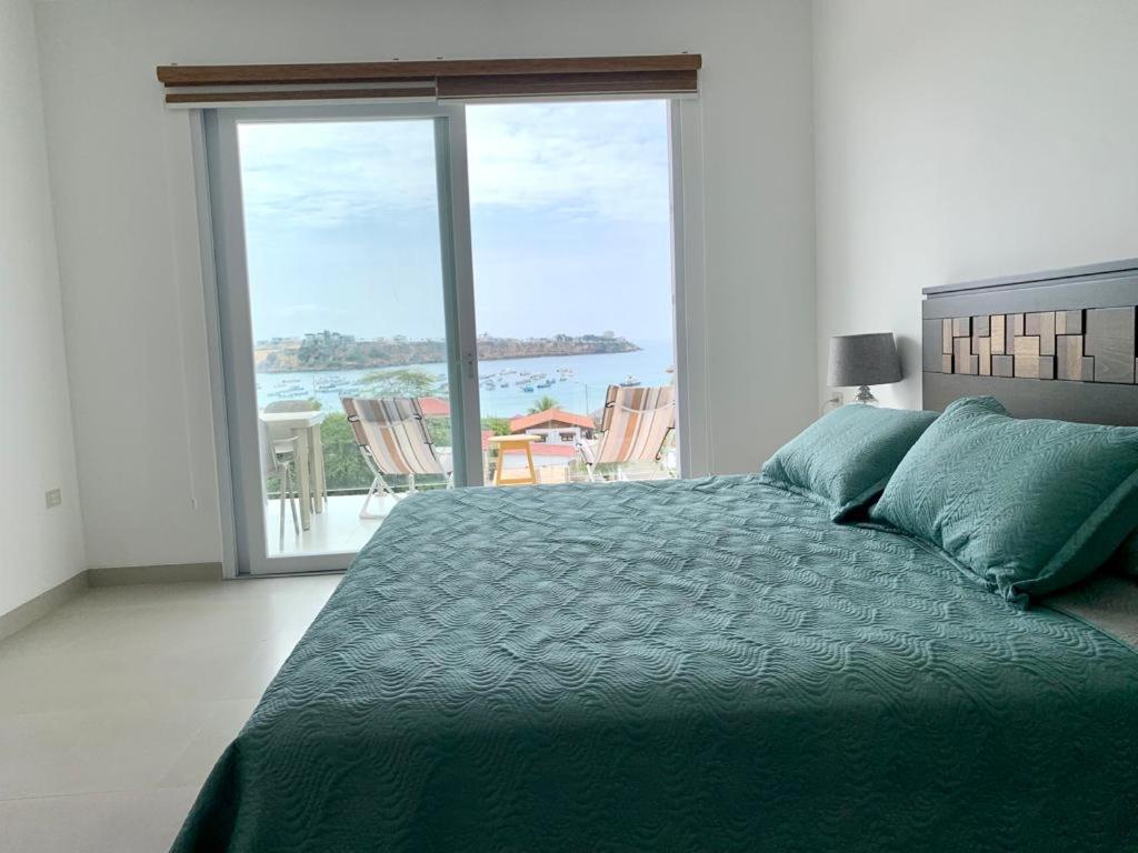 a bedroom with a bed with a view of the ocean at Casa Lobster Bay in Ayangue