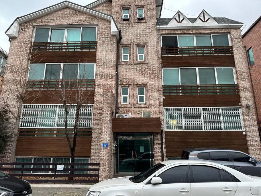 a building with a car parked in front of it at Hwarangdae Station One-room House in Seoul