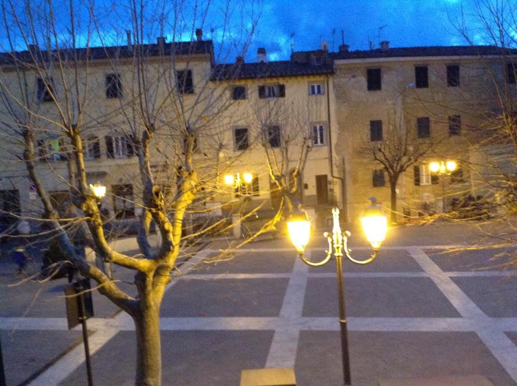 an empty street with lights in front of a building at Casa Anna in Castagneto Carducci
