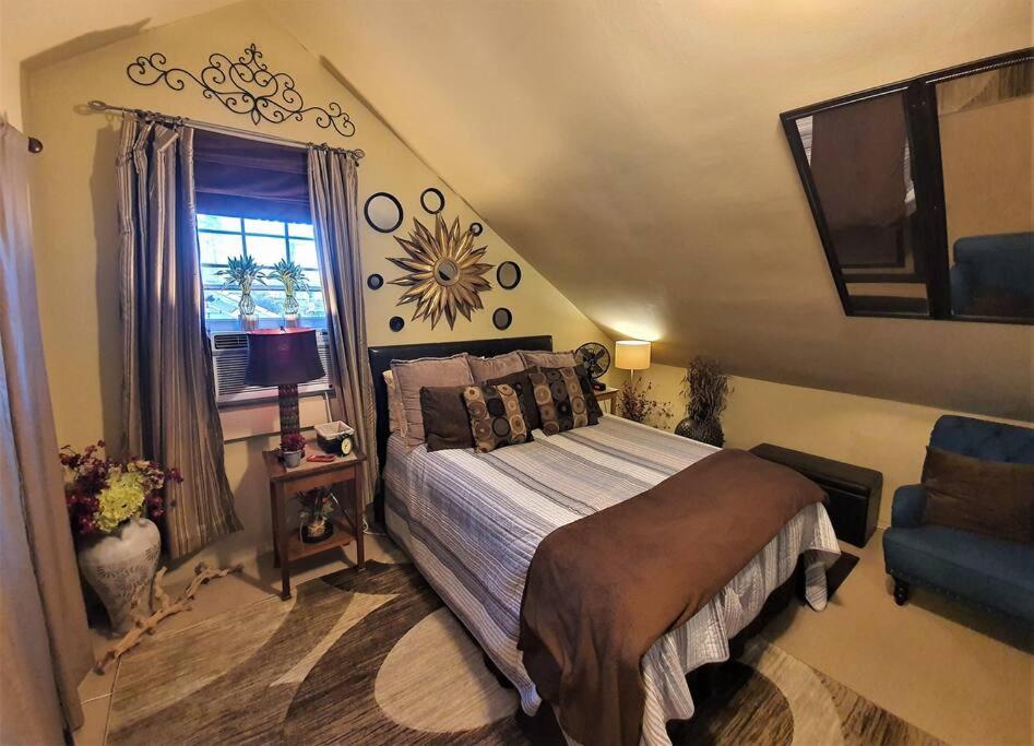 a bedroom with a large bed and a window at Tropical OASIS Getaway with a Private Pool & Spa in New Orleans