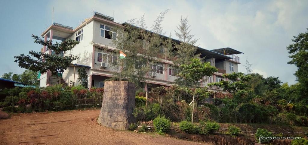 a house with a large tree stump in front of it at Viraz Valley in Gokarna
