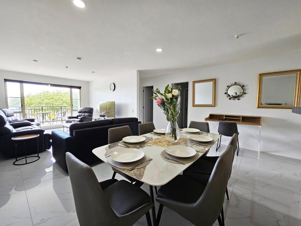a dining room and living room with a table and chairs at Spacious and Luxury, City Fringe Bliss! in Wellington