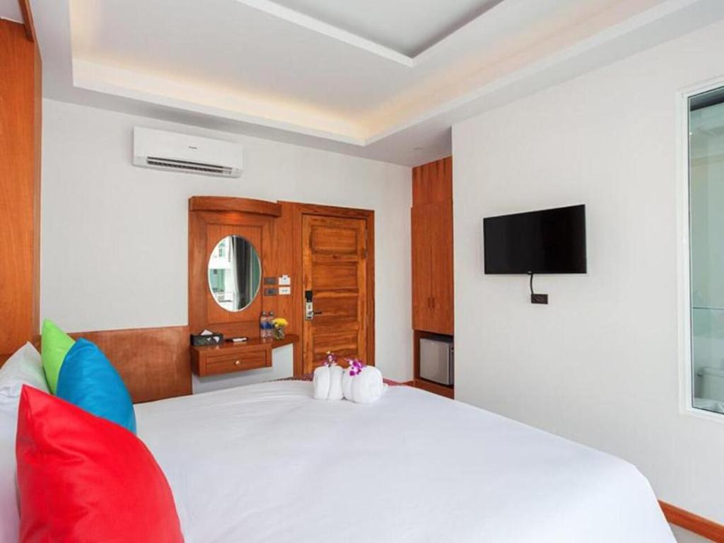 Postel nebo postele na pokoji v ubytování The Samui Beach Resort