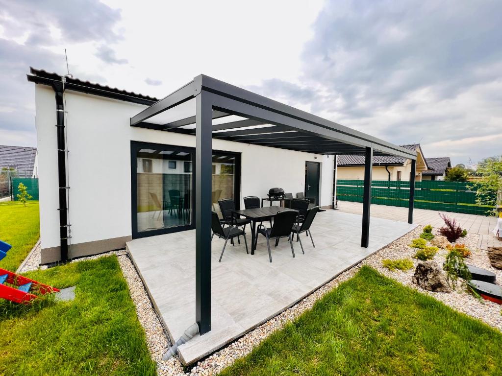 a pavilion with a table and chairs on a patio at Apartment house Tatras in Liptovský Mikuláš