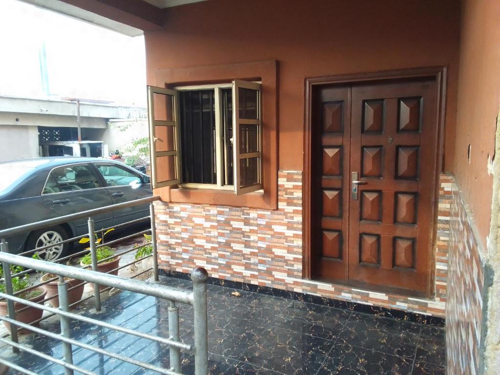 a door on the side of a house with a car at Light house hotel in Lekki