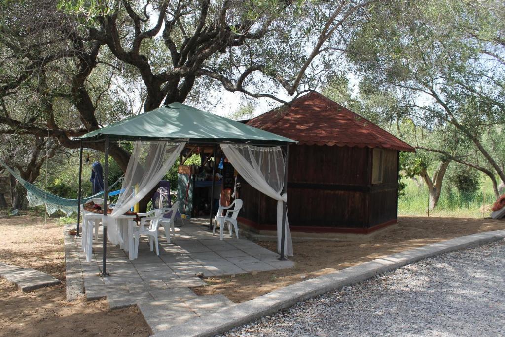 a gazebo with a table and chairs in front at Camping Amanti Del Mare in Palinuro