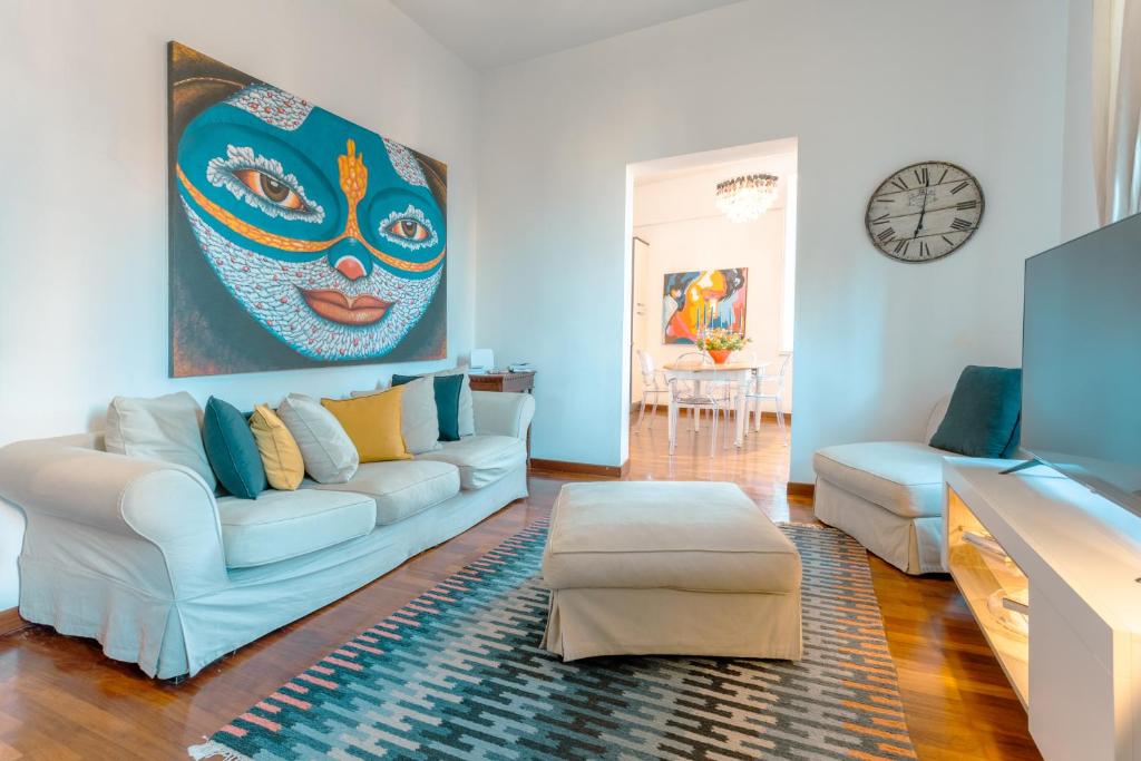 ローマにあるPiazza di Spagna Apartmentの白いソファと絵画が飾られたリビングルーム