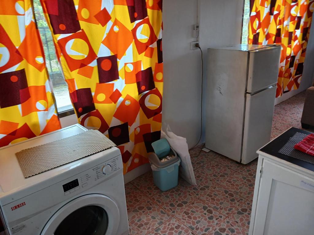 a kitchen with a washing machine and a refrigerator at Olosara Haven in Nayawa