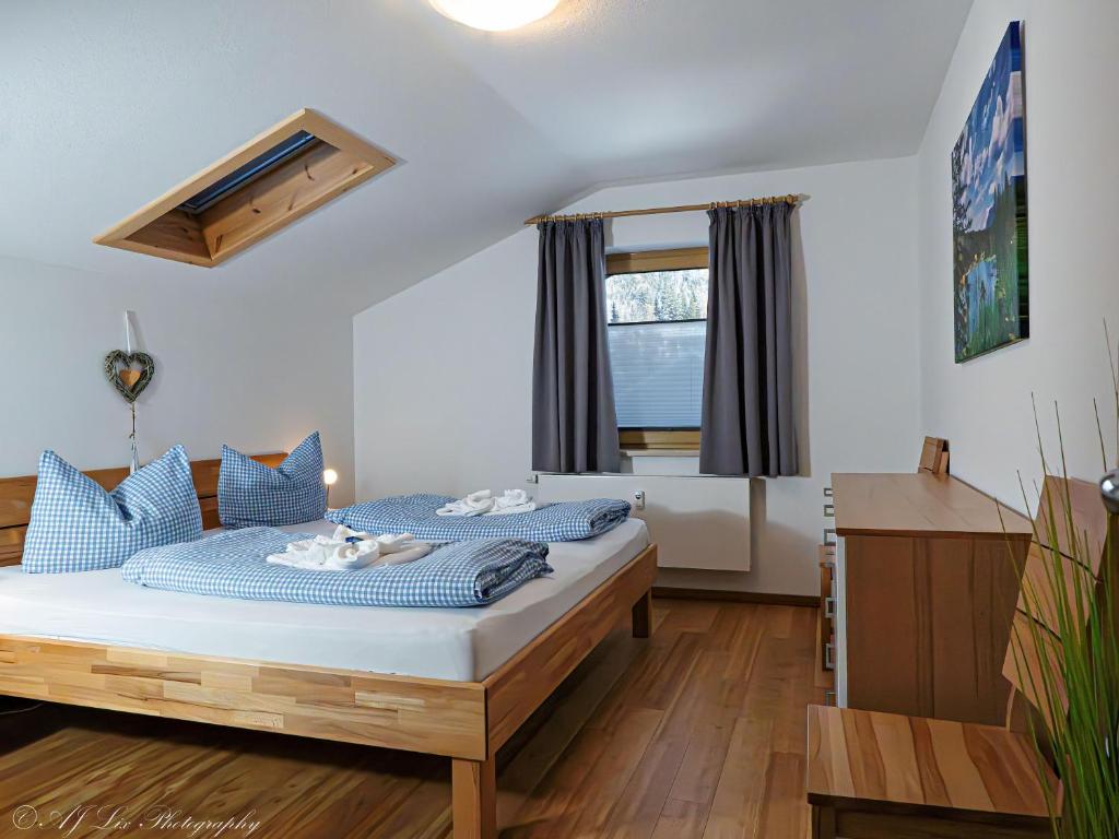 a bedroom with a bed with blue pillows at Fewo Am Mühlbach 5 AMB5 in Mittenwald