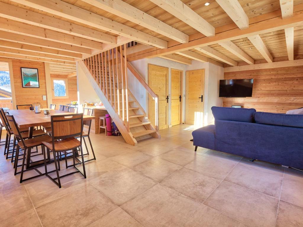 a living room with a blue couch and a table at Chalet Notre-Dame-de-Bellecombe, 6 pièces, 12 personnes - FR-1-505-99 in Notre-Dame-de-Bellecombe