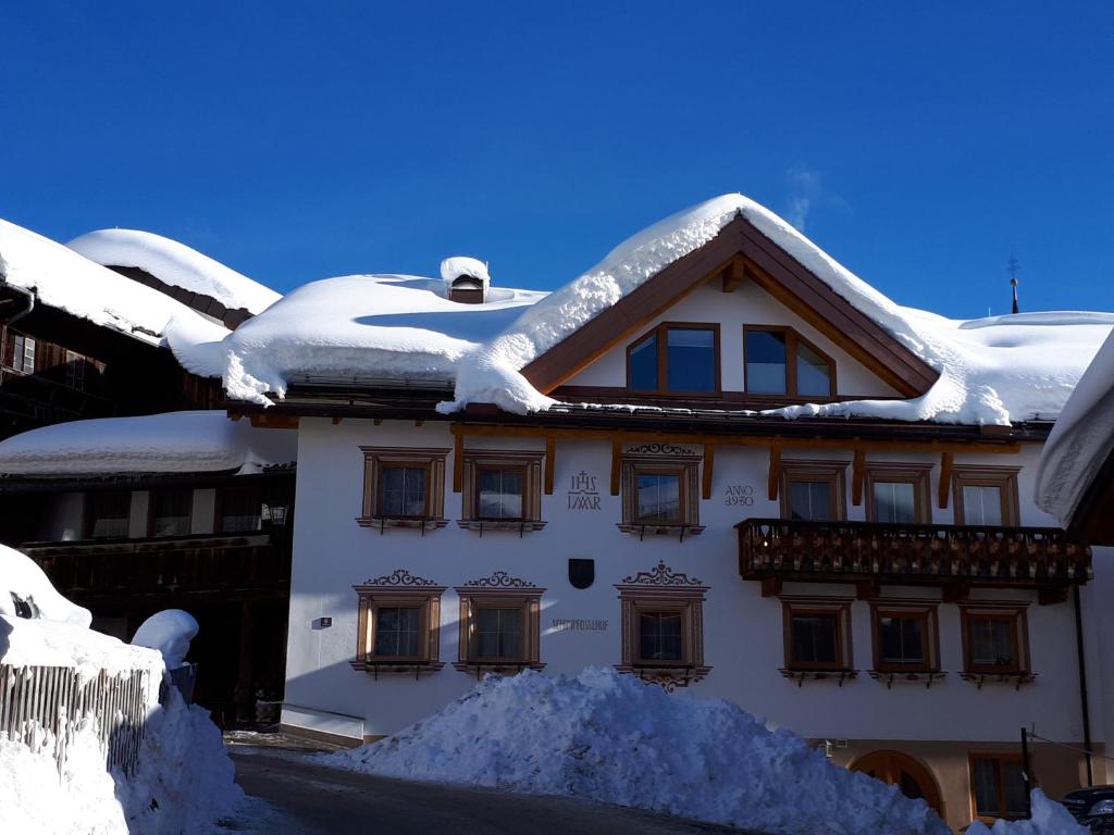 a house with snow on the roof at Schimpfösslhof in Fiss