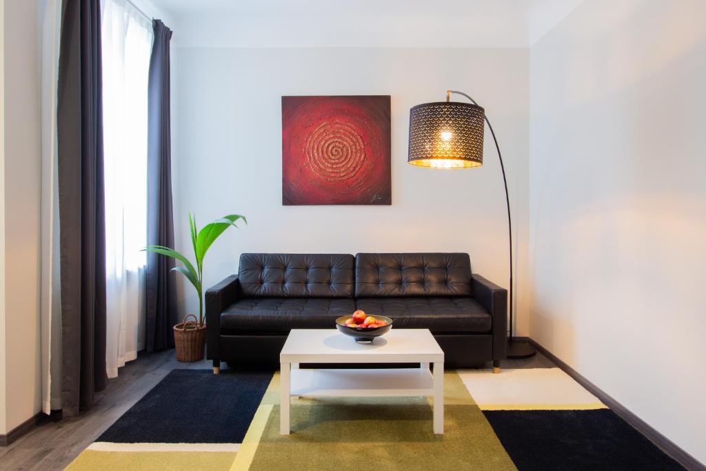 a living room with a couch and a table at Laima V. Apartments in Riga