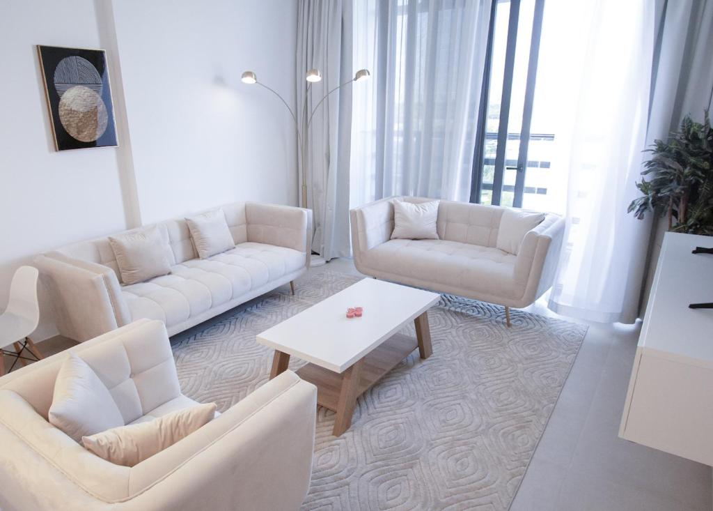 a living room with two couches and a coffee table at 40 Minutes drive to Burj Khalifa in Sharjah