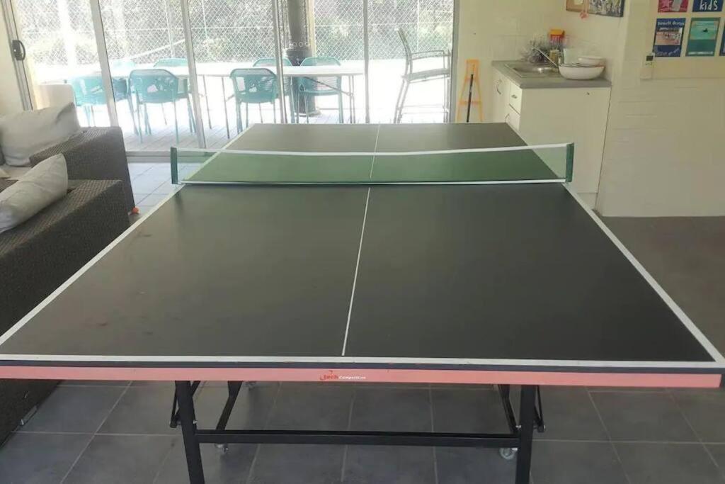 a large ping pong table in a living room at Bec's Beach House Getaway in Batemans Bay