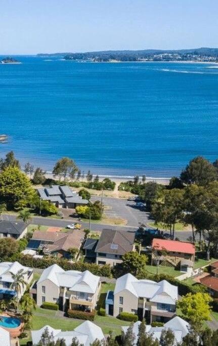 an aerial view of a houses and the water at Bec's Beach House Getaway in Batemans Bay