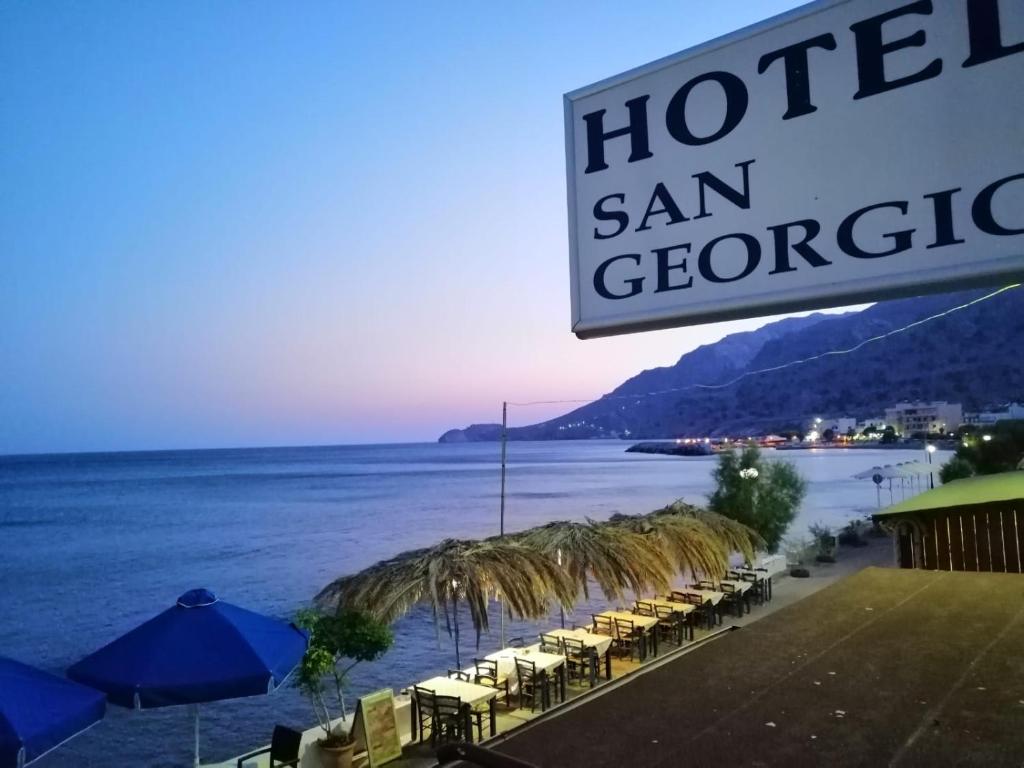 a sign for a hotel san gregorico with a view of the ocean at San Georgio Hotel in Tsoutsouros