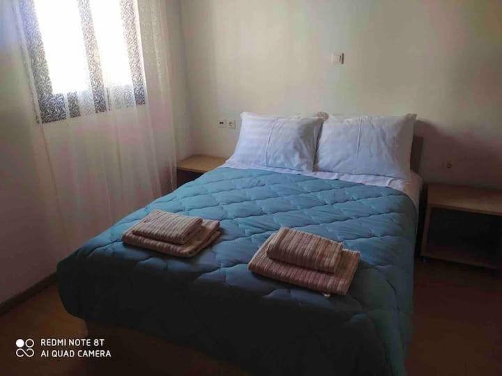 a bedroom with a bed with two pillows on it at Casa del Sol in Arónion