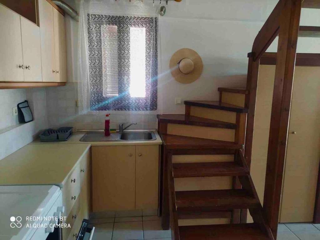 a kitchen with a staircase leading up to a sink at Casa del Sol in Arónion