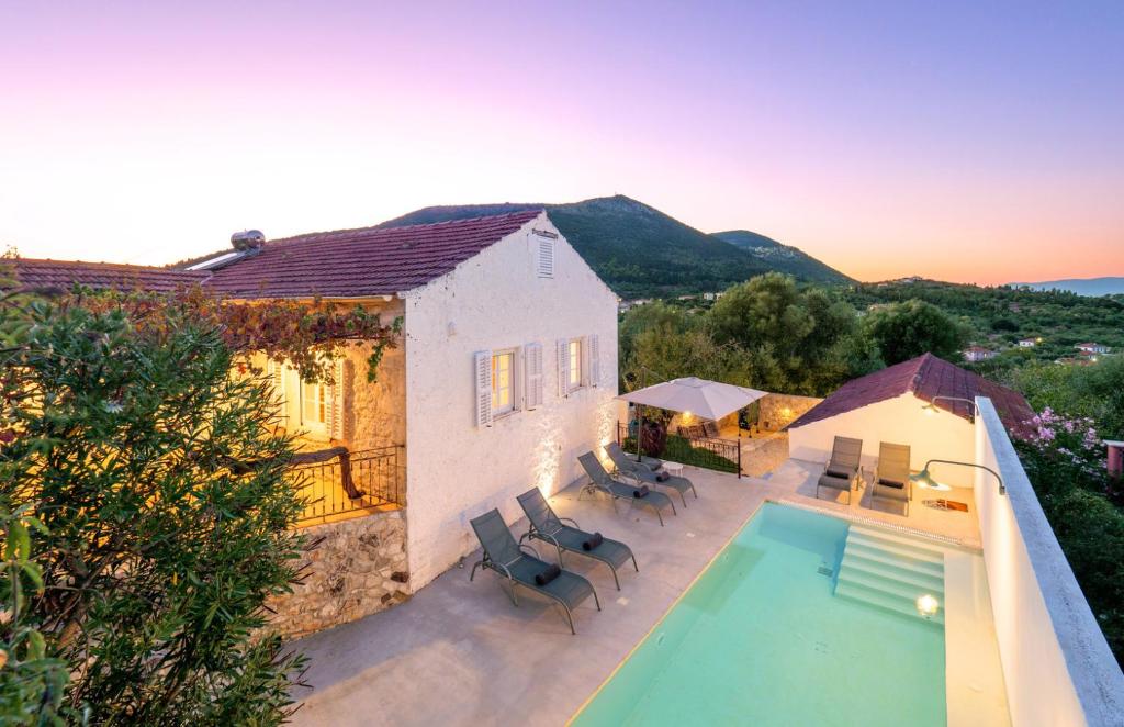 an aerial view of a house with a swimming pool at The Village House in Stavros