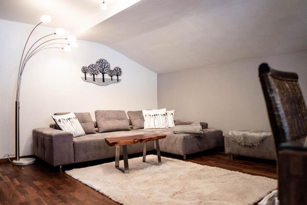 a living room with a couch and a table at Appartement Mountainrelax Gastein in Dorfgastein