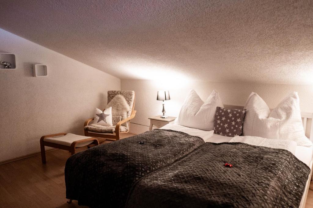 a bedroom with a large bed and a chair at Appartement Mountainrelax Gastein in Dorfgastein